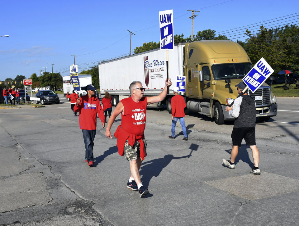 Scott G. Alexander, center, Local 900, a final area inspector at Ford Michigan Assembly Plant walks the picket line in front of the plant on the first day of the strike, Friday, Sept. 15, 2023, in Wayne, Mich. (Clarence Tabb Jr./Detroit News via AP)