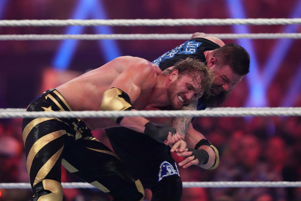 Jan 27, 2024; St. Petersburg, FL, USA; Kevin Owens (black attire) and Logan Paul (gold attire) battle during the United States Championship match during the Royal Rumble at Tropicana Field. Mandatory Credit: Joe Camporeale-USA TODAY Sports