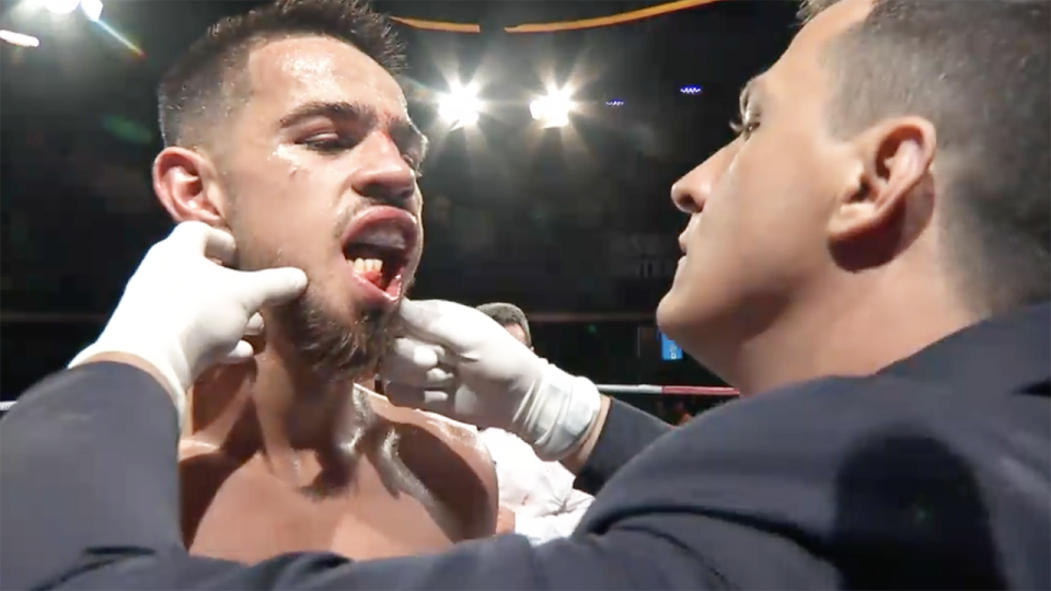 Australian boxer Banjamin Hussain is pictured being examined by the fight doctor during his fight against Ben Mahoney.