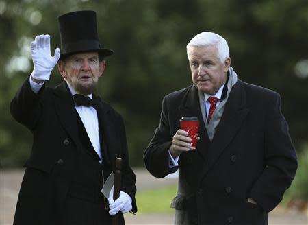 James Getty (L), portraying U.S. President Abraham Lincoln, chats with Pennsylvania Republican Governor Tom Corbett (R) before delivering the Gettysburg Address at the Gettysburg National Cemetery in Pennsylvania November 19, 2013. REUTERS/Gary Cameron