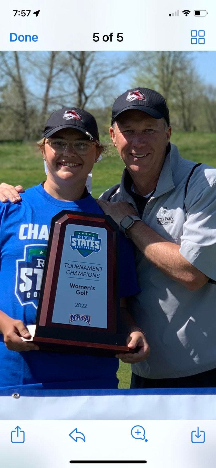 IU East freshman golfer Olivia Sanders (left) shows off the River States Conference championship trophy with her dad, Aaron.