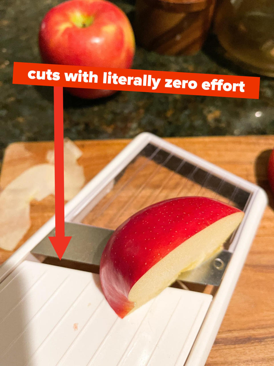 Thinly slicing apples on a mandoline slicer with caption "cuts with literally zero effort"