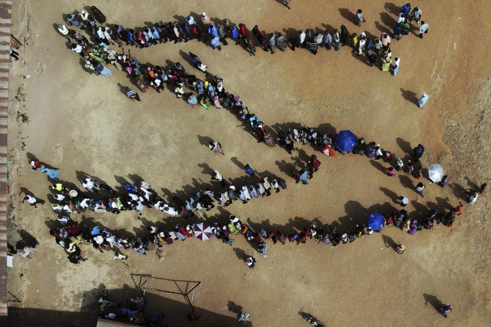 FILE - In this Saturday, Feb. 23, 2019 file photo, Nigerians line up to cast their votes in the presidential election at the Narayi primary school in Kaduna, Nigeria. These African stories captured the world's attention in 2019 - and look to influence events on the continent in 2020. (AP Photo/Jerome Delay, File)