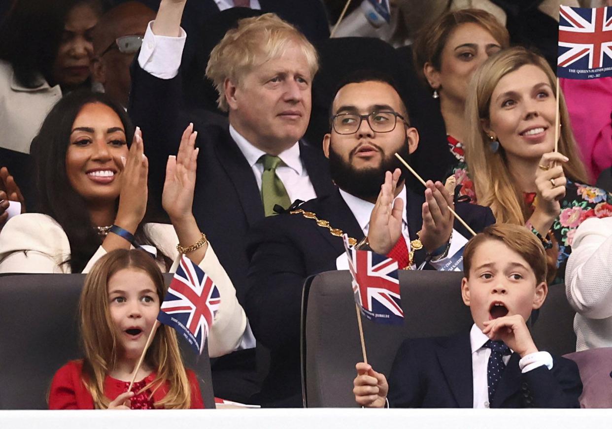 Prince George, right, and Princess Charlotte watch the Platinum Jubilee concert in front of Buckingham Palace in London on Saturday, June 4, 2022, on the third of four days of celebrations to mark the Platinum Jubilee.