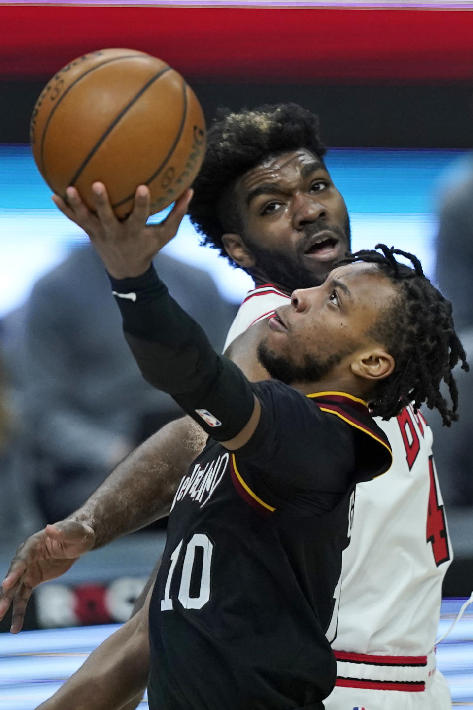 Cleveland Cavaliers' Darius Garland drives to the basket against Chicago Bulls' Patrick Williams during the second half of an NBA basketball game Wednesday, April 21, 2021, in Cleveland. (AP Photo/Tony Dejak)