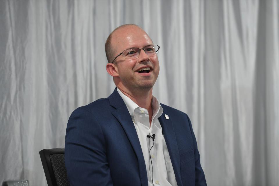 USD Senior Associate AD for Facilities & Operations Corey Jenkins discuss with Rotarian Joel Dykstra on topics about the changing landscape in college athletics at the Holiday Inn Sioux Falls City Centre on Monday, July 31, 2023.