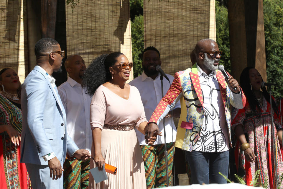 Oprah greets guests with gospel singer Bebe Winans.