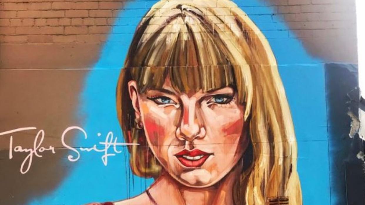 A huge Taylor Swift mural has popped up in Sydney ahead of her arrival for her three shows, but the artwork has received mixed reviews. The large portrait of Swift is on Crown Street in Surry Hills and portrays her wearing a red wrap dress, with her eyes angled downward. Picture: Instagram