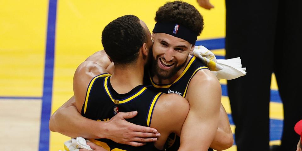 Steph Curry and Klay Thompson hug during the 2022 playoffs.