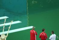 <p>Officials look at the Olympic diving pool. REUTERS/Antonio Bronic </p>