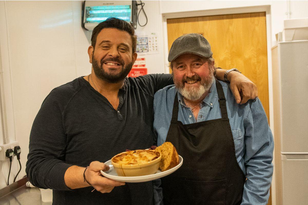 Mike Bryan (right) cooked Adam Richman an authentic Lancashire hotpot <i>(Image: Food Network)</i>