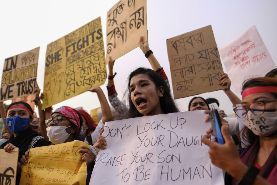 Women’s rights activists and others protesting against gender based violence hold placards outside the Parliament in Dhaka, Bangladesh, Friday, Oct.9, 2020. Bangladesh's Cabinet has approved an increase in the maximum punishment in rape cases to death from life imprisonment after a series of recent sexual assaults triggered protests. (AP Photo/ Mahmud Hossain Opu)