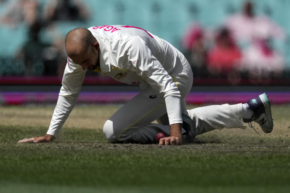 Australia's Ashton Agar fields off his own bowling to South Africa during the fifth day of their cricket test match at the Sydney Cricket Ground in Sydney, Sunday, Jan. 8, 2023. (AP Photo/Rick Rycroft)