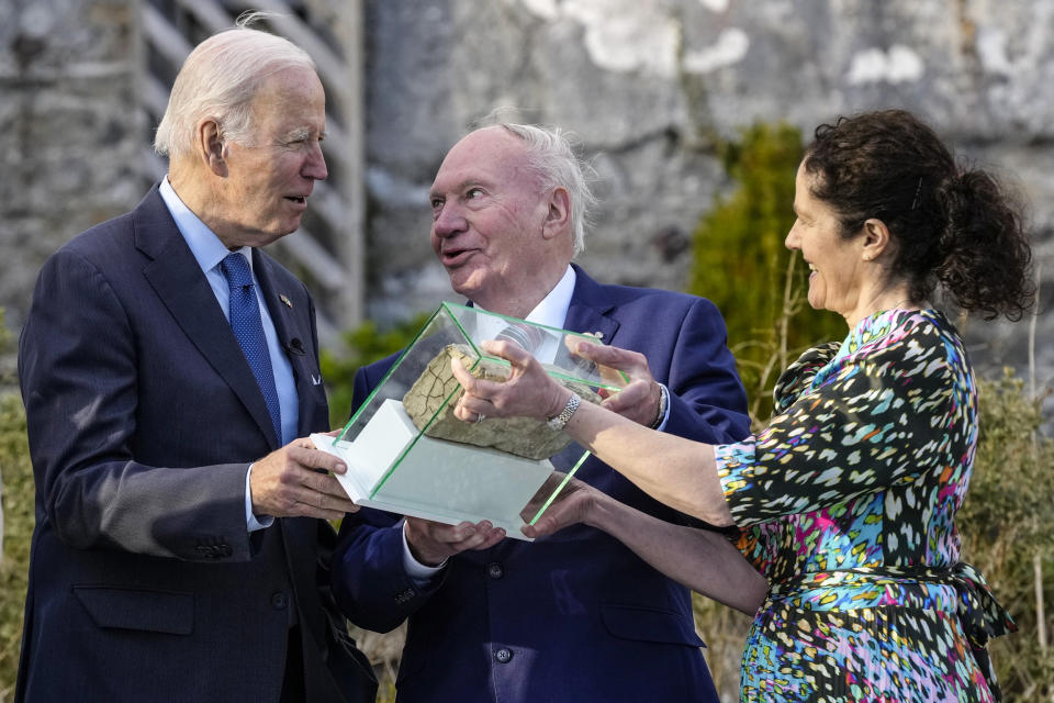 Image: Ernie Caffrey and his daughter Miriam Caffrey present President Joe Biden with a brick from the fireplace of the Blewitt family homestead as he visits the North Mayo Heritage Center in County Mayo, Ireland, on April 14, 2023. (Patrick Semansky / AP)