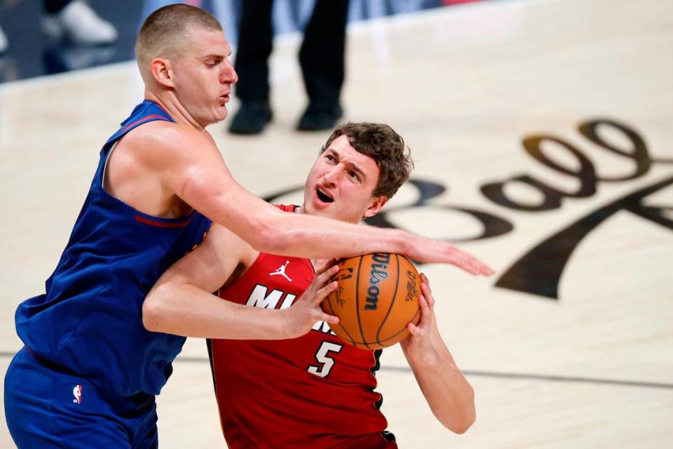 Denver Nuggets center Nikola Jokic (15) knocks the ball away from Miami Heat forward Nikola Jovic (5) during the fourth quarter in game one of the 2023 NBA Finals at Ball Arena.