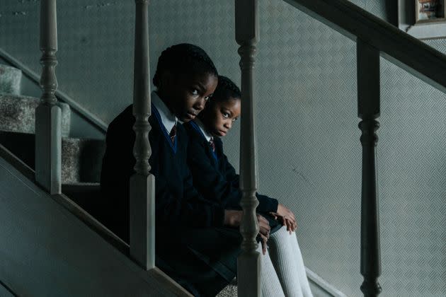 (From left) The sisters (Leah Mondesir Simmons and Eva-Arianna Baxter) watch their family from a distance in their childhood home. (Photo: Courtesy of Jakub Kijowski/Focus)