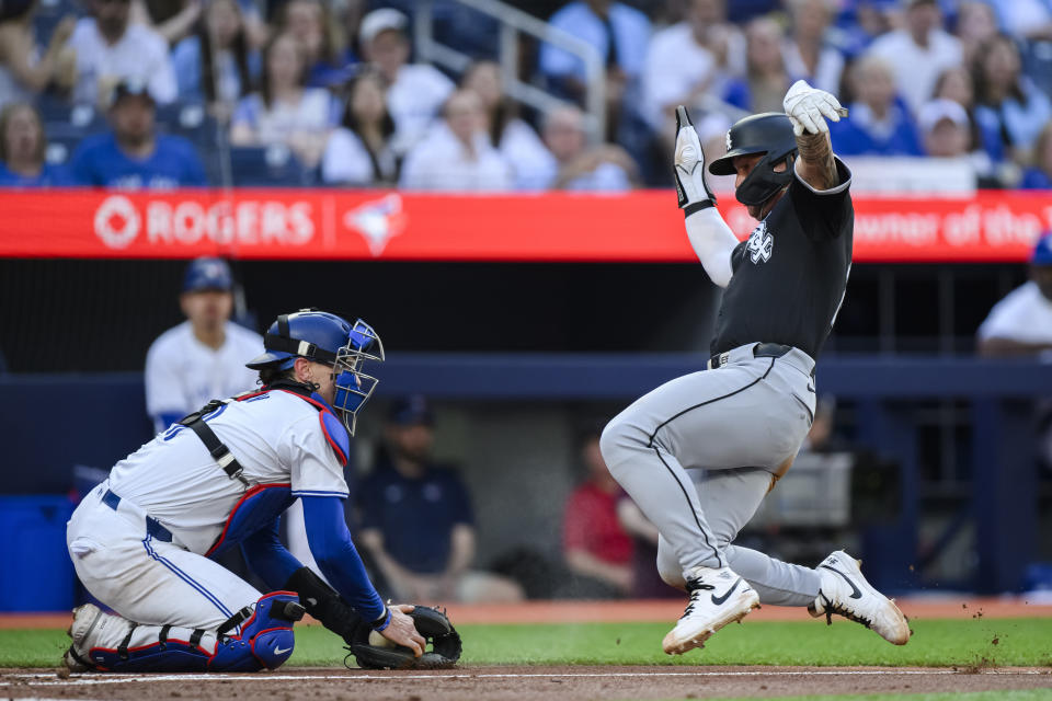 Chicago White Sox's Korey Lee scores ahead of the tag from Toronto Blue Jays catcher Danny Jansen during the second inning of a baseball game Tuesday, May 21, 2024, in Toronto. (Christopher Katsarov/The Canadian Press via AP)