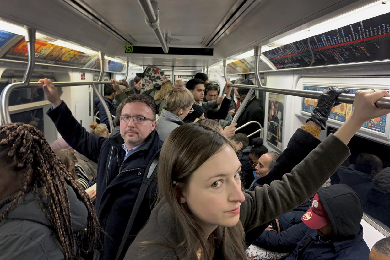 Commuters ride in a subway during the morning rush hour, Thursday, Nov. 15, 2018, in New York. (AP Photo/Wong Maye-E)