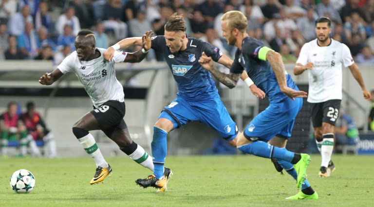 Hoffenheim defender Ermin Bicakcic (C) and midfielder Kevin Vogt (R) track Liverpool midfielder Sadio Mane during the Champions League qualifier in Sinsheim, Germany on August 15, 2017