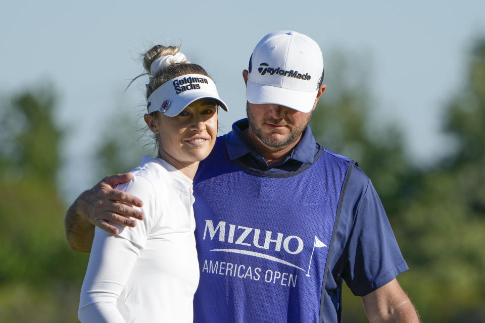 Nelly Korda is hugged by her caddie Jason McDede on the 18th green during the final round of the Mizuho Americas Open golf tournament, Sunday, May 19, 2024, in Jersey City, N.J. (AP Photo/Seth Wenig)