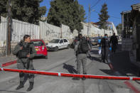 Israeli police officers examine the scene of a stabbing attack in east Jerusalem, Wednesday, Dec. 8, 2021. An Israeli woman was stabbed and lightly wounded in Sheikh Jarrah neighborhood in east Jerusalem on Wednesday. The suspect, a Palestinian female minor, fled the scene and was later arrested inside a nearby school, police said. (AP Photo/Mahmoud Illean)