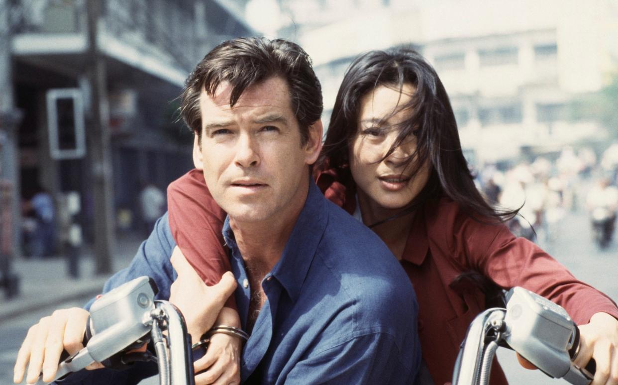 Pierce Brosnan as 007 and Michelle Yeoh as Wai Lin in Tomorrow Never Die's famous motorcycle chase sequence - Keith Hamshere/Getty Images