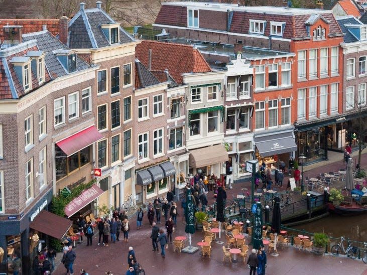 an aerial shot of a crowded street in a town in the netherlands