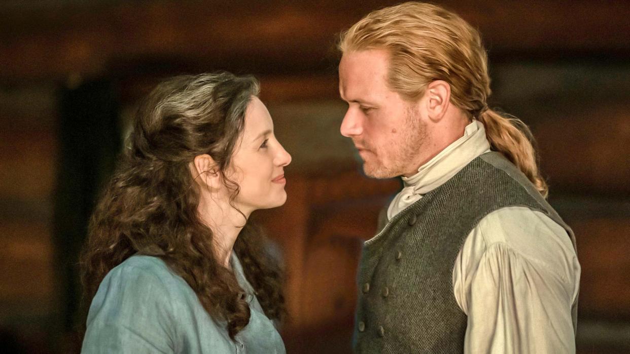  (L to R) Caitríona Balfe as Claire Fraser and Sam Heughan as Jamie Fraser in Outlander season 7 