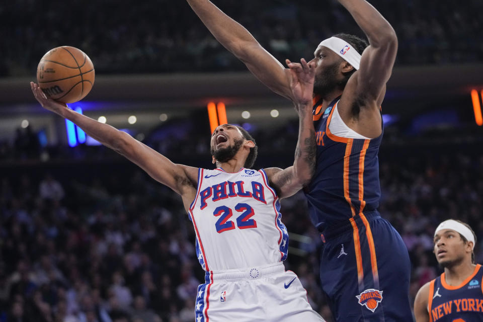 Philadelphia 76ers guard Cameron Payne (22) goes to the basket against New York Knicks forward Precious Achiuwa during the first half of an NBA basketball game Tuesday, March 12, 2024, at Madison Square Garden in New York. (AP Photo/Mary Altaffer)