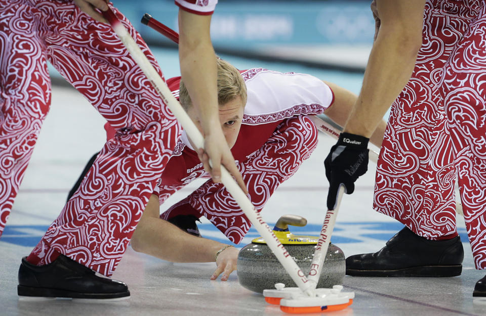 Russia's Petr Dron watches the stone as his team mates sweep the ice during the first day of the men's curling training at the 2014 Winter Olympics, Saturday, Feb. 8, 2014, in Sochi, Russia. (AP Photo/Wong Maye-E)