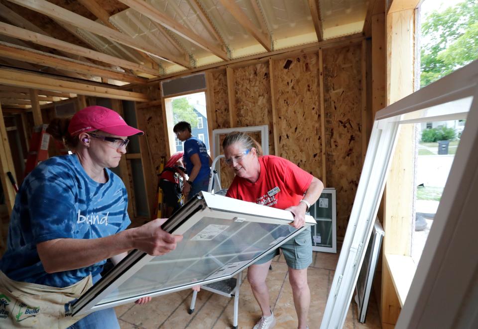 Kim Fahrenkrug, left, of Neenah and Jane Frieders of Appleton install windows during a Habitat for Humanity build located at 530 N. Locust Street Tuesday, August 8, 2023, in Appleton, Wis.Dan Powers/USA TODAY NETWORK-Wisconsin. 