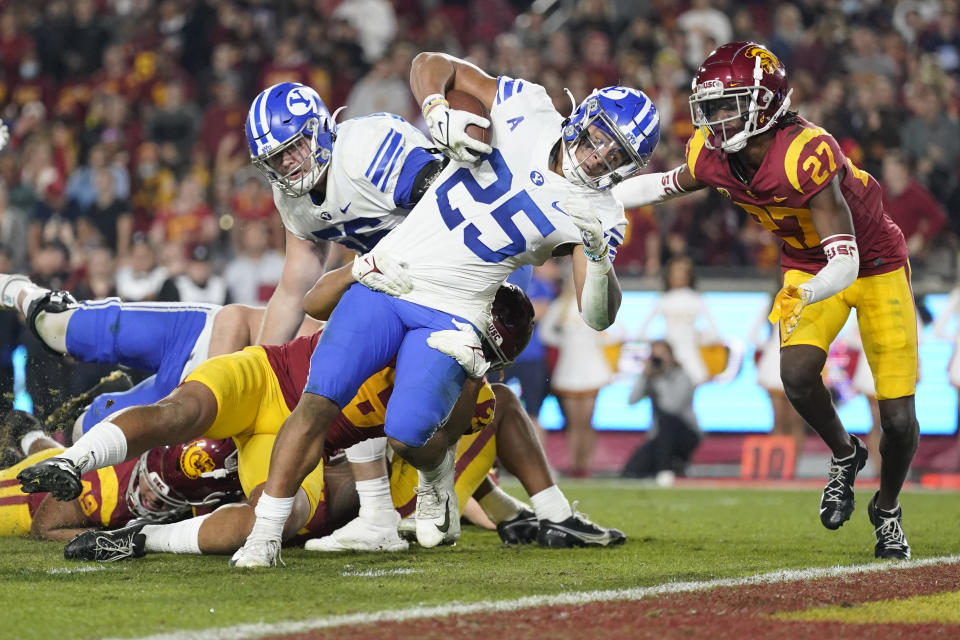 Brigham Young running back Tyler Allgeier (25) falls in to the end zone for a touchdown during the first half of an NCAA college football game against Southern California in Los Angeles, Saturday, Nov. 27, 2021. (AP Photo/Ashley Landis)
