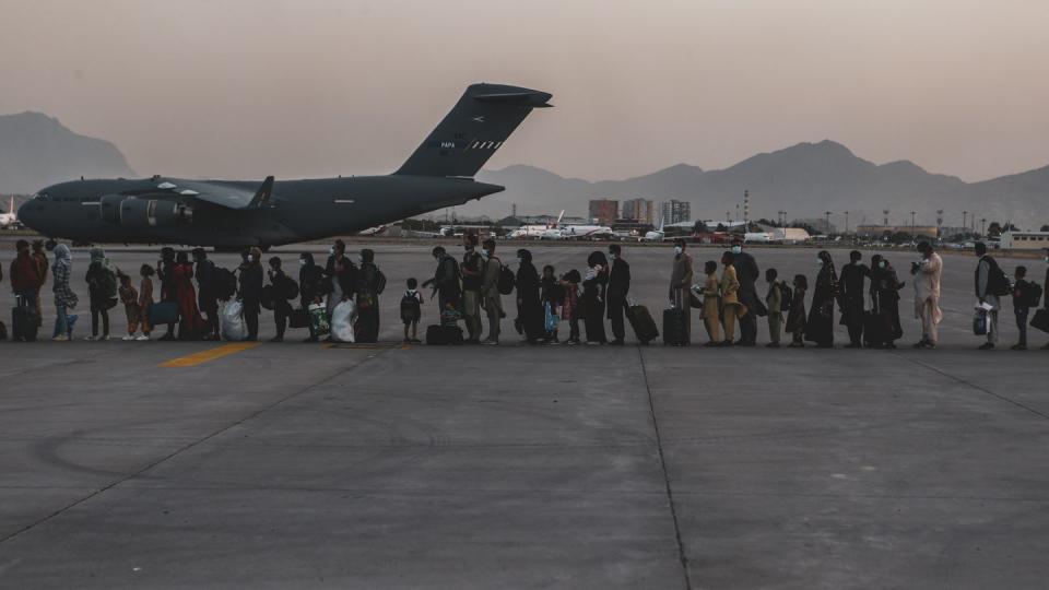 Evacuees wait to board a Boeing C-17 Globemaster III during an evacuation at Hamid Karzai International Airport, Kabul, Afghanistan, Aug. 23, 2021. (Sgt. Isaiah Campbell/Marine Corps)