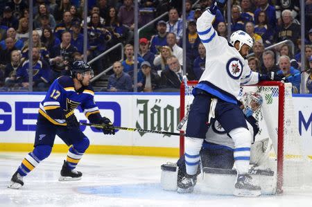 Apr 20, 2019; St. Louis, MO, USA; Winnipeg Jets defenseman Dustin Byfuglien (33) collides with goaltender Connor Hellebuyck (37) as St. Louis Blues left wing Jaden Schwartz (17) looks for the rebound during the first period in game six of the first round of the 2019 Stanley Cup Playoffs at Enterprise Center. Mandatory Credit: Jeff Curry-USA TODAY Sports