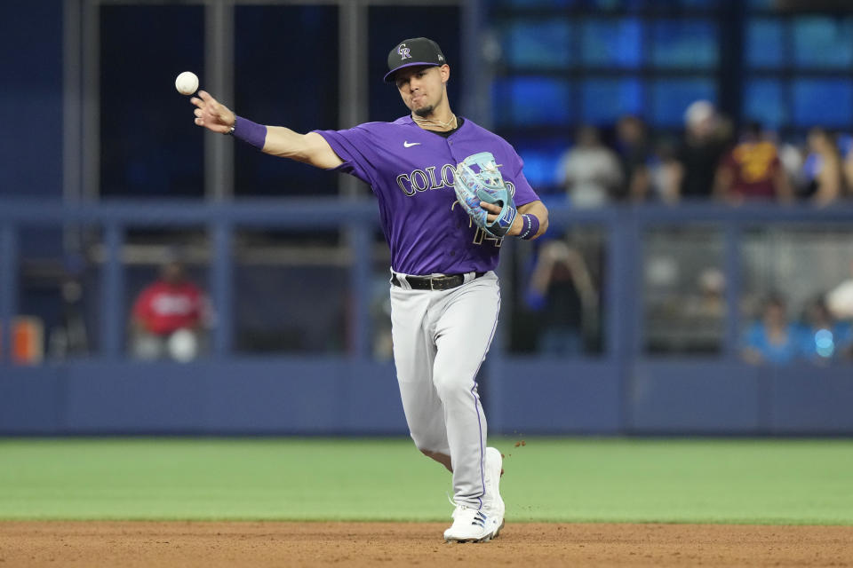 Colorado Rockies shortstop Ezequiel Tovar (14) throws to first base on a hit by Miami Marlins' Jean Segura during the fourth inning of a baseball game, Saturday, July 22, 2023, in Miami. (AP Photo/Marta Lavandier)