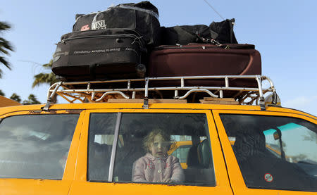 A Palestinian girl looks out of a car upon her return with her family to Gaza, at Rafah border crossing in the southern Gaza Strip January 8, 2019. REUTERS/Ibraheem Abu Mustafa