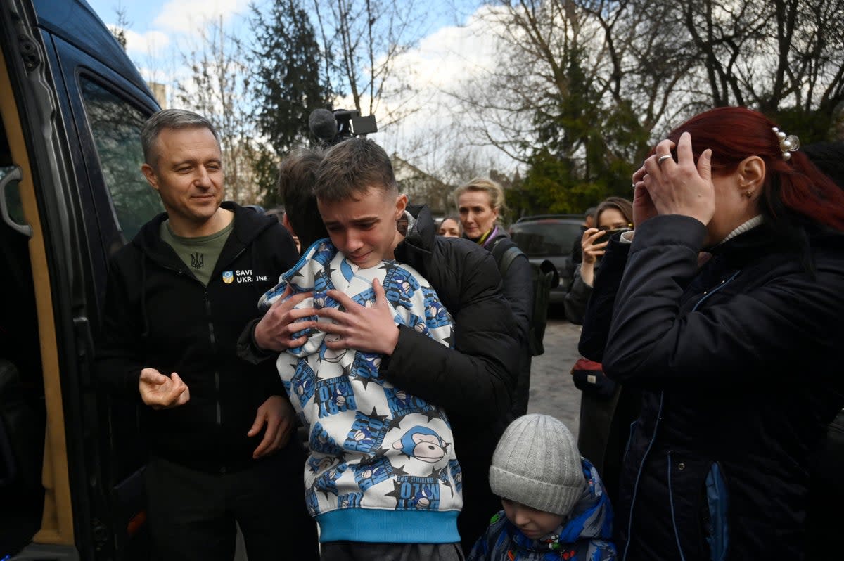 Inessa (right) meets her son Vitaly after the bus delivering him and more than a dozen other children back from Russian-held territory arrived in Kyiv (AFP via Getty Images)