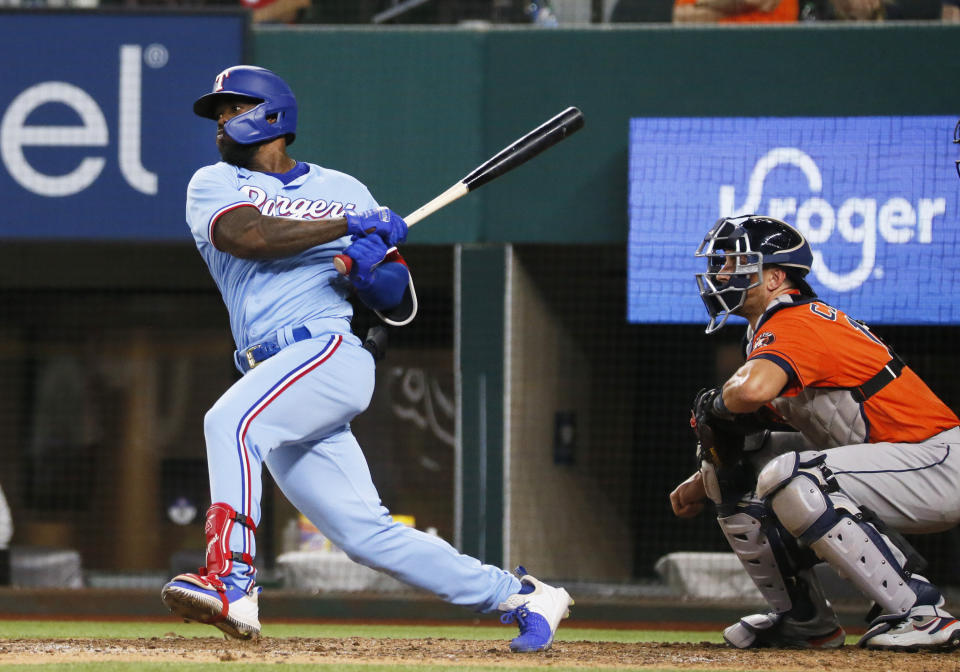 Texas Rangers' Adolis Garcia follows thru on a walk-off RBI single against the Houston Astros in the tenth inning of a baseball game in Arlington, Texas, Sunday, May 23, 2021. (AP Photo/Ray Carlin)