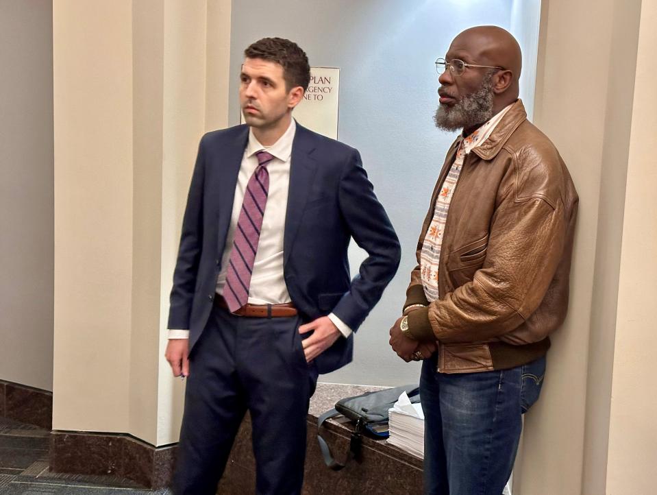 Calvin Riley Sr., right, and Assistant Public Defender Eric Henely wait outside a Leon County courtroom on Friday, April 5, 2024, ahead of his trial on a DUI charge. Riley's lawyers allege that a Tallahassee Police Department officer poured out a bottle of alcohol and planted it in his car the night of his arrest.