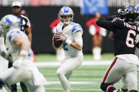 Detroit Lions quarterback Tim Boyle (12) works against the Atlanta Falcons during the first half of an NFL football game, Sunday, Dec. 26, 2021, in Atlanta. (AP Photo/John Bazemore)