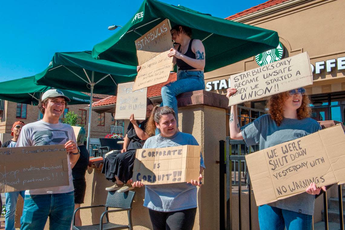 Starbuck employees picket at the Starbucks location on the Country Club Plaza on Tuesday, Aug. 23, 2022. The store abruptly closed Monday afternoon notifying employees and guests that the location had permanently closed according to signs posted on the doors.