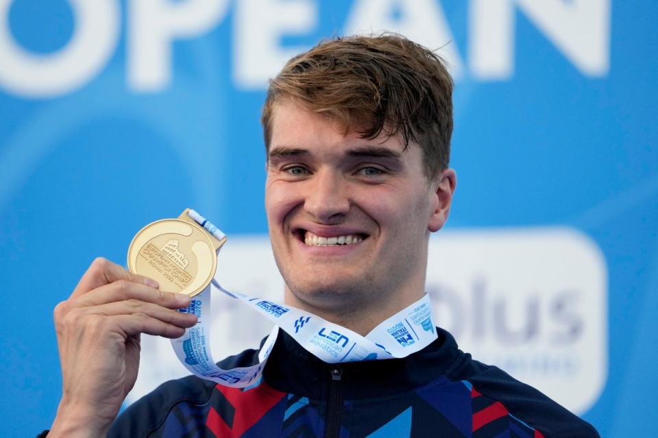 Great Britain’s James Wilby celebrates on the podium after winning gold in the men’s 200m breaststroke at the European Swimming Championships in Rome (Gregorio Borgia/AP) (AP)