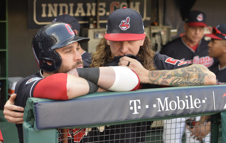 Cleveland Indians’ Jason Kipnis, left, is hugged by starting pitcher Mike Clevinger after the Houston Astros defeated the Indians 11-3 in Game 3 of a baseball American League Division Series, Monday, Oct. 8, 2018, in Cleveland. (AP Photo/Phil Long)