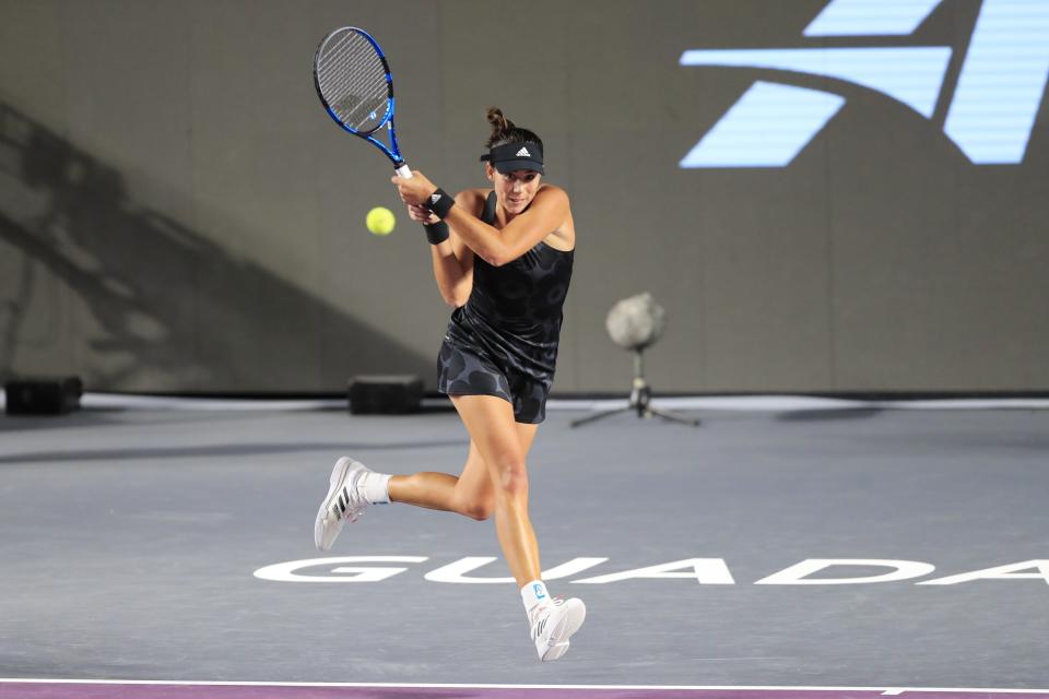 Garbine Muguruza of Spain, returns a shot to Karolina Pliskova of the Czech Republic, during a match of the Mexican Tennis WTA Finals in Guadalajara, Mexico, Wednesday, Nov. 10, 2021. (AP Photo/Refugio Ruiz)