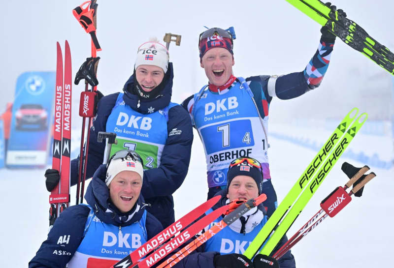 Norway's Biathlon team (top left to bottom right) Sturla Holm Laegreid, Johannes Thingnes Boe, Endre Stroemsheim and Tarjei Boe celebrate the victory of the men's relay 4 x 7.5 km of the Biathlon World Cup in the Lotto Thuringia Arena at Rennsteig. Martin Schutt/dpa