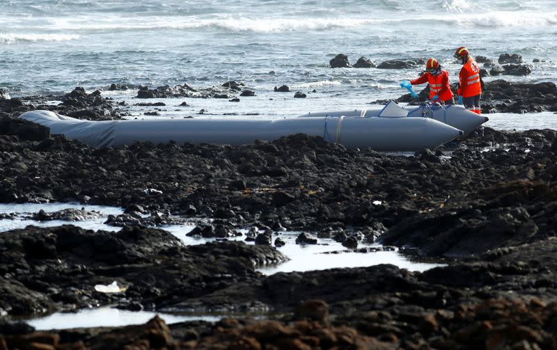 Rescue workers search for bodies after a boat with 46 migrants from the Maghreb region capsized in the beach of Orzola