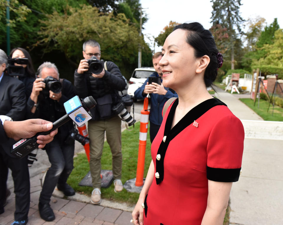 Huawei Chief Financial Officer, Meng Wanzhou, stops to talk to media while leaving her Vancouver home to appear in British Columbia Supreme Court, in Vancouver, on October 1, 2019. - The 47-year-old Huawei chief financial officer was detained during a stopover at the Vancouver airport in December 2018, on a US warrant. The US wants to put Meng on trial for fraud for allegedly violating Iran sanctions and lying about it to US banks -- accusations her lawyers dispute. Meng -- a rising star whose father Ren Zhengfei founded Huawei and over three decades grew it into a global telecom giant -- expressed surprise when told she was being arrested, according to a transcript of her speaking with authorities after her flight from Hong Kong landed. (Photo by Don MacKinnon / AFP)        (Photo credit should read DON MACKINNON/AFP via Getty Images)