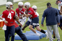 New England Patriots quarterbacks Jarrett Stidham (4), Mac Jones (50) and Cam Newton (1) run drills during NFL football practice in Foxborough, Mass., Friday, June 4, 2021. (AP Photo/Mary Schwalm)