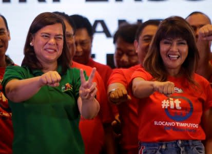 Davao City Mayor Sara Duterte-Carpio (L)  and Ilocos Norte Governor Imee Marcos gestures during an alliance meeting with local political parties in Paranaque, Metro Manila in Philippines, August 13, 2018. Picture taken August 13, 2018. REUTERS/Czeasar Dancel