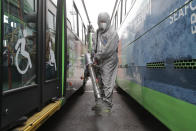 A worker wearing a protective suit sprays disinfectant as a precaution against the coronavirus at a bus garage in Seoul, South Korea, Wednesday, Feb. 26, 2020. The number of new virus infections in South Korea jumped again Wednesday and the U.S. military reported its first case among its soldiers based in the Asian country, with his case and many others connected to a southeastern city with an illness cluster. (AP Photo/Ahn Young-joon)